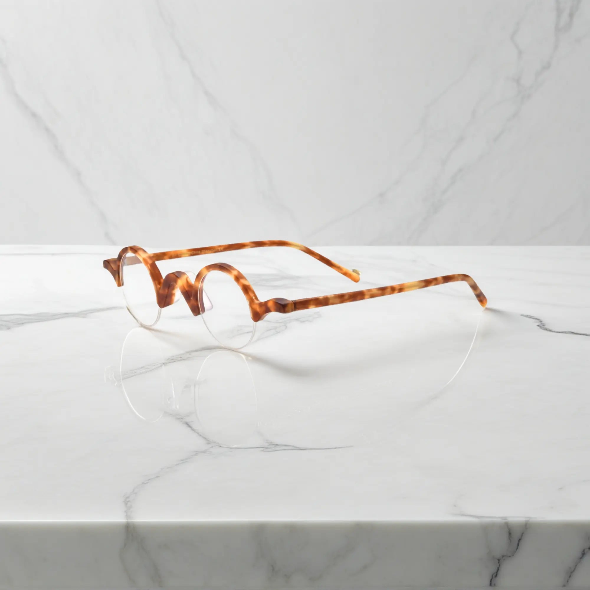 Side perspective of VoyueLens™ Tortoiseshell semi-rimless browline eyeglasses showcasing matte acetate structure.